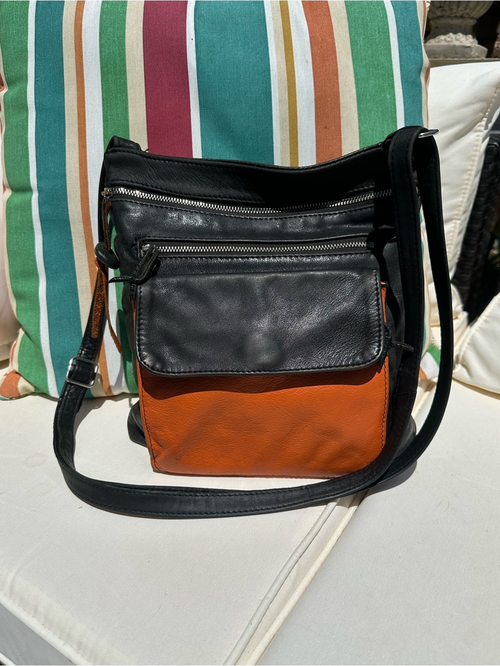 Stone and Co black and orange crossbody leather bag with adjustable straps